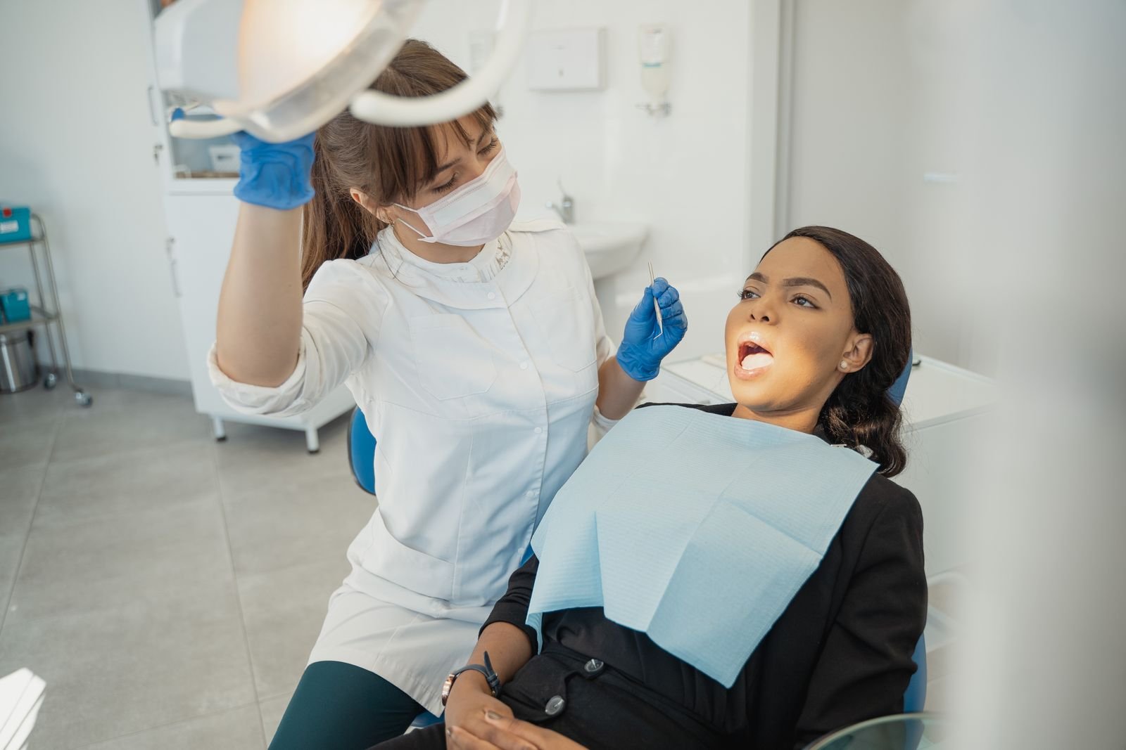 Illustrative photograph of a dentist caring for an adult patient